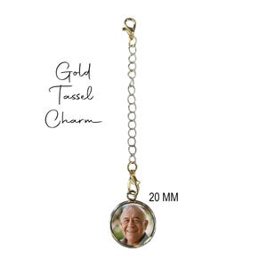 May include: Gold tassel charm with a 20 mm round photo locket featuring a man's smiling face.
