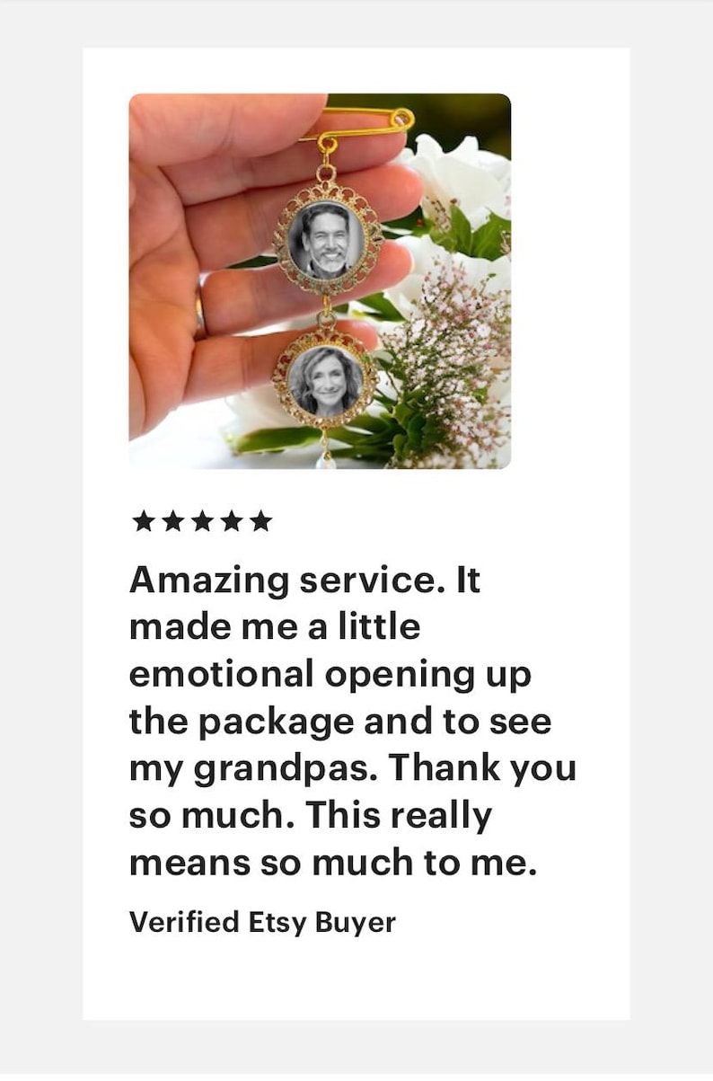 May include: A gold-toned brooch with two round photo frames. The frames are decorated with a filigree design and feature black and white photos of two people. The brooch is attached to a safety pin.