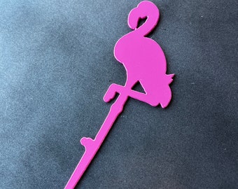 May include: A pink flamingo silhouette with a long, thin stem. The flamingo is standing on one leg with its head bent down. The stem is attached to the flamingo's body.