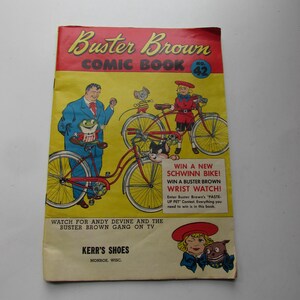 May include: A vintage comic book cover featuring Buster Brown, a cartoon character, riding a red bicycle. The cover also includes the text "Buster Brown Comic Book No. 42" and "Watch for Andy Devine and the Buster Brown Gang on TV".