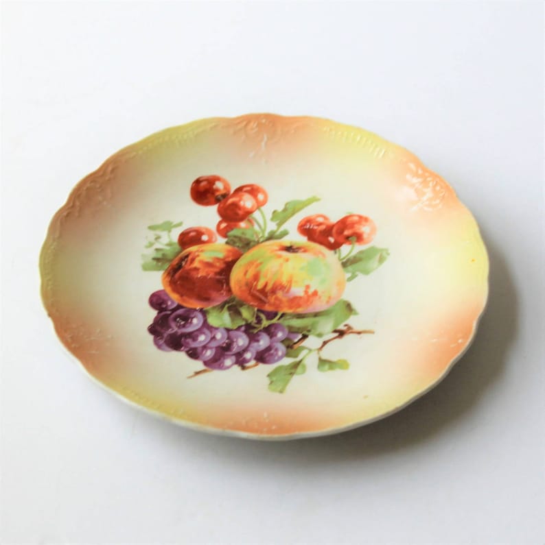 China 076 apples W.E.B cottage d\u00e9cor Vintage cottage chic china plates and grapes on pink and yellow background Co cherries