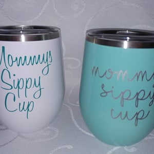 May include: Two stainless steel tumblers with a white and teal blue finish. The tumblers have the text "Mommy's Sippy Cup" written on them in a teal blue color.