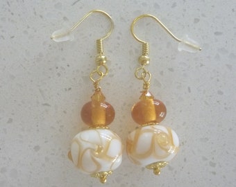 Amber and white earrings on gold ear wires with lampwork glass beads. Artisan lampwork, SRA, Chrys Art Glass