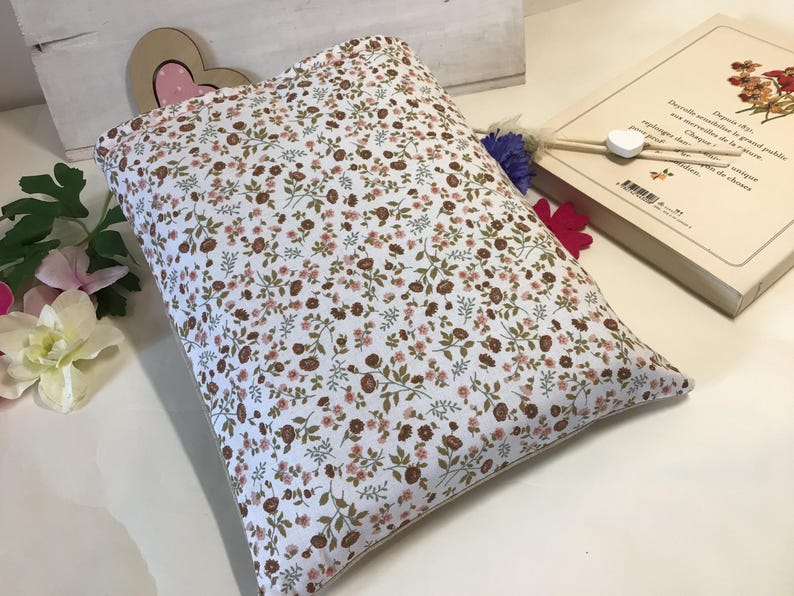 May include: A white pillowcase with a brown and pink floral pattern. The pillowcase is made of a soft, comfortable fabric and has a subtle sheen.