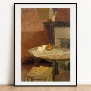 May include: An oil painting print in a black frame depicting an interior scene with a round table holding a white teacup and a brown teapot on a newspaper. A small square stool with a tan book sits in the foreground against a dark red wall.