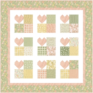 K&ouml;nnte beinhalten: Ein Quiltblockmuster mit einer Herzform in der Mitte jedes Blocks. Die Bl&ouml;cke bestehen aus verschiedenen floralen und karierten Stoffen in Rosa-, Gr&uuml;n- und Gelbt&ouml;nen.