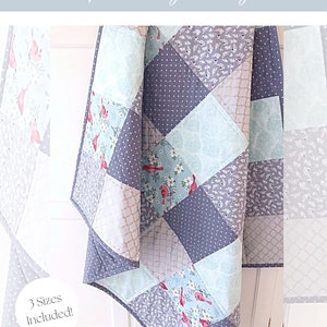May include: A quilting pattern for a quilt called "Skipping Stones" with a beginner-friendly design. The quilt features a patchwork design with a variety of fabrics in shades of blue, gray, and white. The quilt is made up of squares and rectangles, and the pattern is easy to follow. The pattern includes instructions for three sizes of quilts. The pattern is called "MCD-1029".