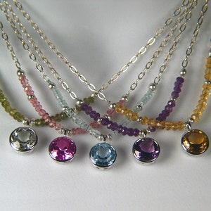 May include: Five silver necklaces with different coloured gemstone beads and matching pendant charms. The necklaces feature green, pink, blue, purple, and yellow gemstones.