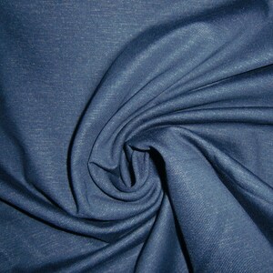 May include: A close-up of a dark blue fabric with a subtle textured pattern. The fabric is folded and draped, showcasing its soft and smooth texture.