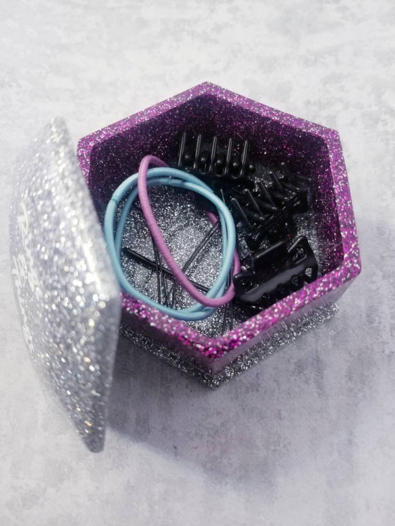 2.75 wide X 1.75 tall Hot pink and silver glitter hexagon shaped resin jewelry box with lid reading Rings /& things