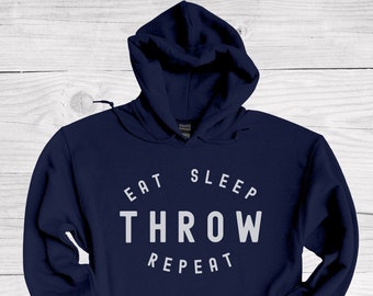 May include: Navy blue hooded sweatshirt with the text "Eat Sleep Throw Repeat" in white.