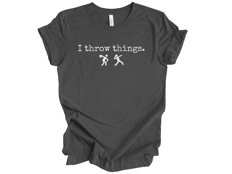 May include: A dark gray t-shirt with the text "I throw things." in white. Two stick figures are shown throwing a ball to each other.