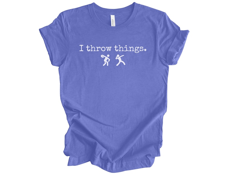 May include: A purple t-shirt with the text "I throw things." and two stick figures throwing a ball.
