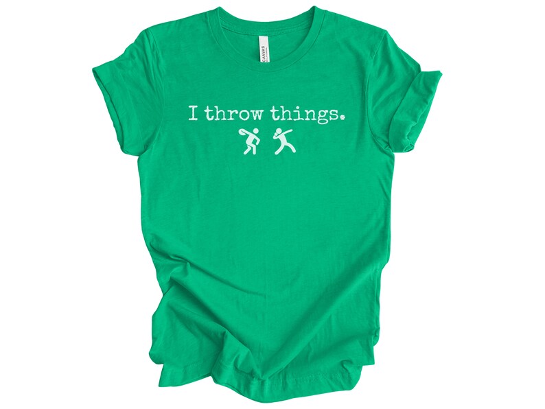 May include: A green t-shirt with the text "I throw things." and a white silhouette of two people throwing a ball.
