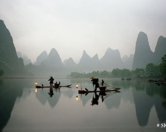 Fishermen in China with cormorant birds on Li River.