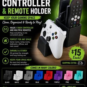 May include: A black 3D-printed plastic stand designed to hold one white Xbox controller and multiple remote controls. The stand features a dedicated slot for a controller and a separate compartment for remotes, shown in a variety of colours including black, white, grey, blue, red, purple, pink, and teal.