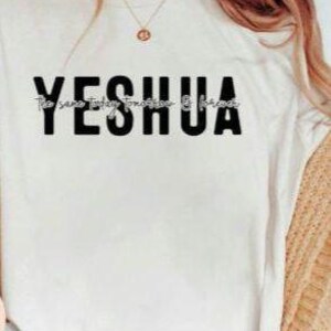 May include: White t-shirt with the word "YESHUA" printed in black letters. The text "The same yesterday, today & forever" is printed in smaller letters below the word "YESHUA".