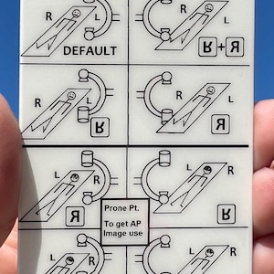 May include: A white plastic medical reference card with diagrams illustrating patient positioning for imaging. The card has a hole at the top and includes text such as "DEFAULT" and "Prone Pt. To get AP Image use."