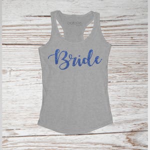 May include: Gray tank top with the word "Bride" in blue glitter lettering.