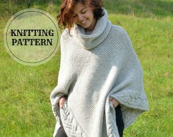 May include: A gray knitted poncho with a high cowl neck and cable knit detail. The poncho is worn by a person standing in a grassy field.
