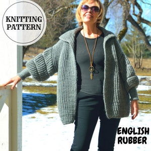 May include: A gray knitted cardigan with a hood and long sleeves. The cardigan is made with a textured stitch pattern called English rubber. The model is wearing the cardigan with black pants and a black shirt.