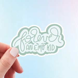 May include: A green sticker with the text "forever an emo kid" in white cursive lettering.