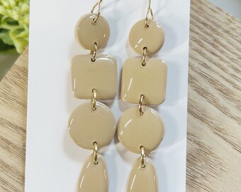 Large size, resin coated cream clay dangle earring