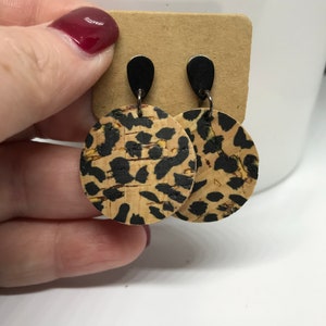 Cheetah print leather disc connected to a black teardrop stud