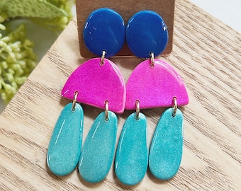 Large size, resin coated shimmery sapphire blue, hot pink and turquoise linked clay earring