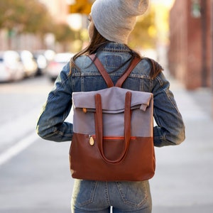 laptop backpack made with gray cotton canvas and brown vegan leather, converts into tote with straps that tuck away