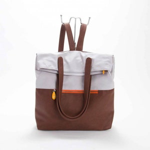 light gray backpack convertible into tote, fits laptop, many pockets, cruelty free and sustainable