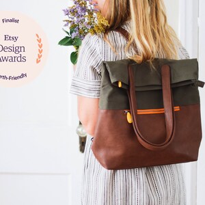 simple work backpack with many pockets, convertible tote straps, orange interior, and water resistant vegan leather