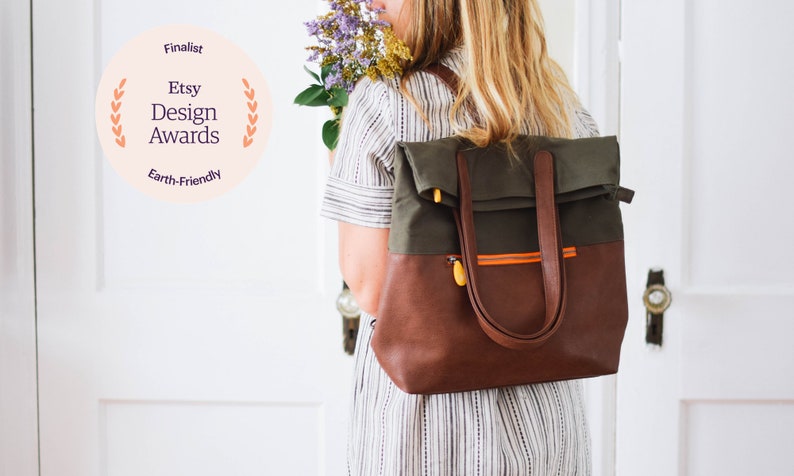 simple work backpack with many pockets, convertible tote straps, orange interior, and water resistant vegan leather