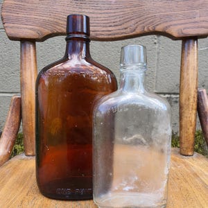 Vintage One Pint Federal Law Forbids Sale Amber Bottle-Full 1/2 Pint Flask Clear bottle