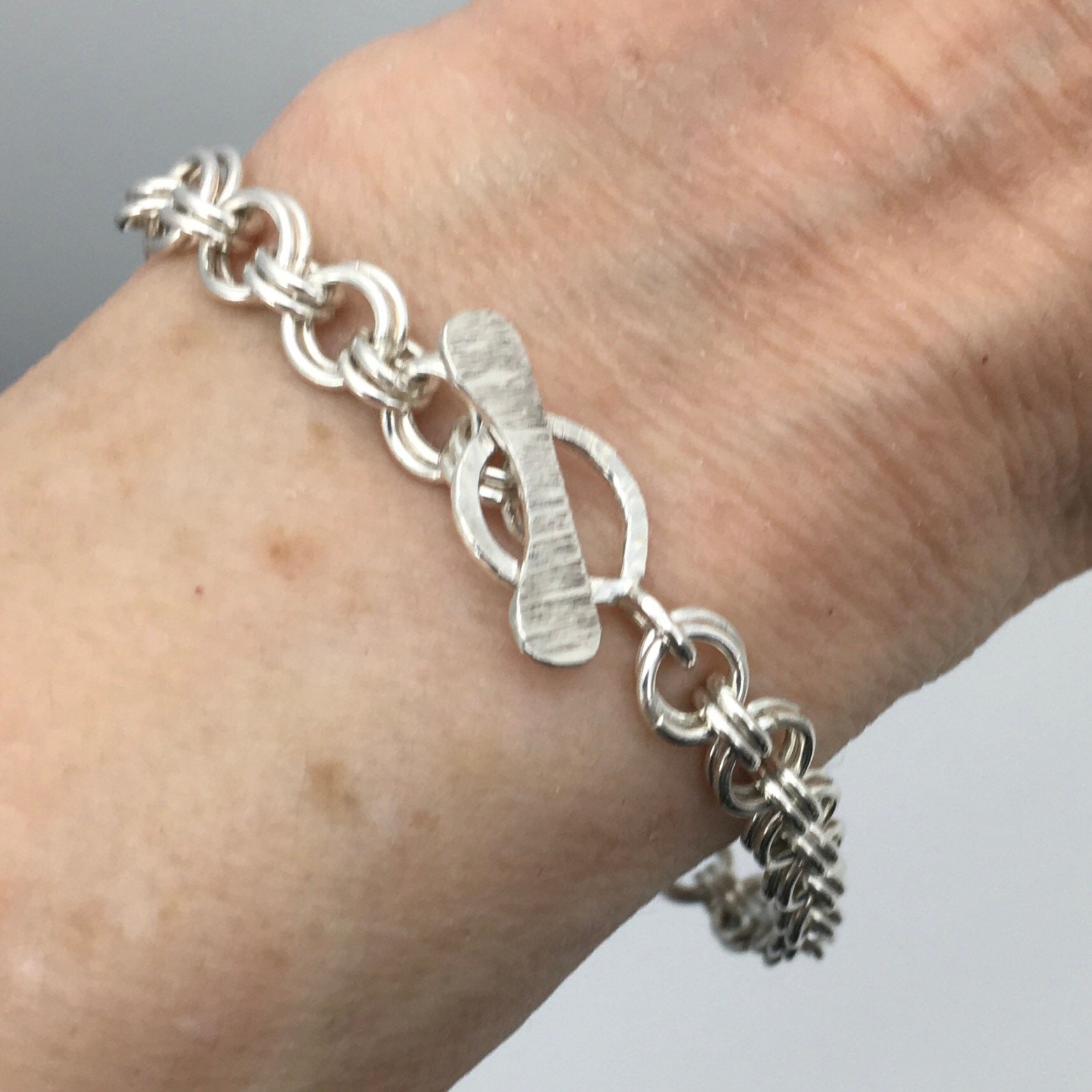 Sterling Silver Chain Bracelet. Hammered Silver. Art Nouveau Inspired Design. Easy popular to Use Toggle Clasp. Graceful. Eye Catching.