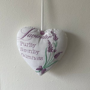 May include: White heart-shaped cushion with lavender embroidery and the words "Lavender, Purity, Serenity, Calmness".