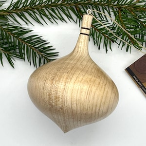 Turned wooden Christmas ornament. Recycled maple wood.
