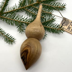 Turned wooden Christmas ornament. Recycled maple wood.  Weathered knot included.