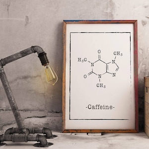 May include: A black and white illustration of the chemical structure of caffeine, with the word "Caffeine" printed below. The illustration is framed and hanging on a wall, with a vintage-style pipe lamp in the foreground.