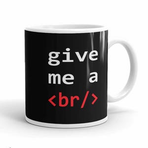May include: A black and white coffee mug with the text "give me a <br/>" in white and red. The mug has a white handle and is 11 ounces.