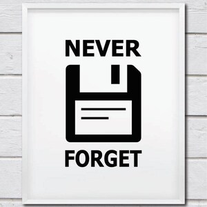 May include: A white framed print with black text that reads "NEVER FORGET" and a black floppy disk icon.