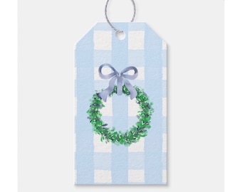 May include: A blue and white gingham gift tag with a green wreath and a blue bow.