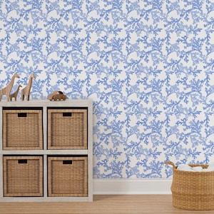Light blue coral wallpaper on the wall of a nursery decorated with baskets and wooden toys.