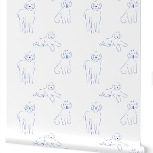 May include: A roll of white wallpaper featuring a repeating pattern of blue line art illustrations of dogs. The design displays two alternating poses of the canine, with some standing and others lying down, rendered in a simple blue ink style.