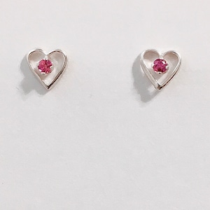 May include: A pair of silver heart-shaped earrings with a small pink gemstone in the center of each heart.