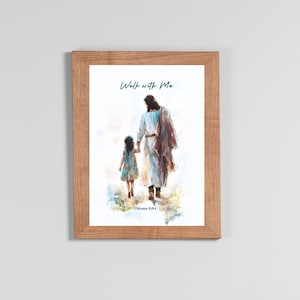 May include: A framed print featuring an illustration of a figure in white robes holding hands with a child. The text "Walk with Me" is above the figures, and "Moses 6:34" is below. The frame is made of light brown wood.