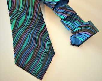 Handpainted silk tie.  Sea motive in shades of  teal, blue and purple colour, and black contour