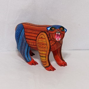 5.5 Inches in Height Original Handmade, Hand Painted Animal, Wood Carving with Irate Eyes, Copper Colored Tail, Colorful Patterned Body, Blue Colored Hind legs, Bear Alebrije, Oaxaca Art, Unique Statue from https://luv2brd.etsy.com