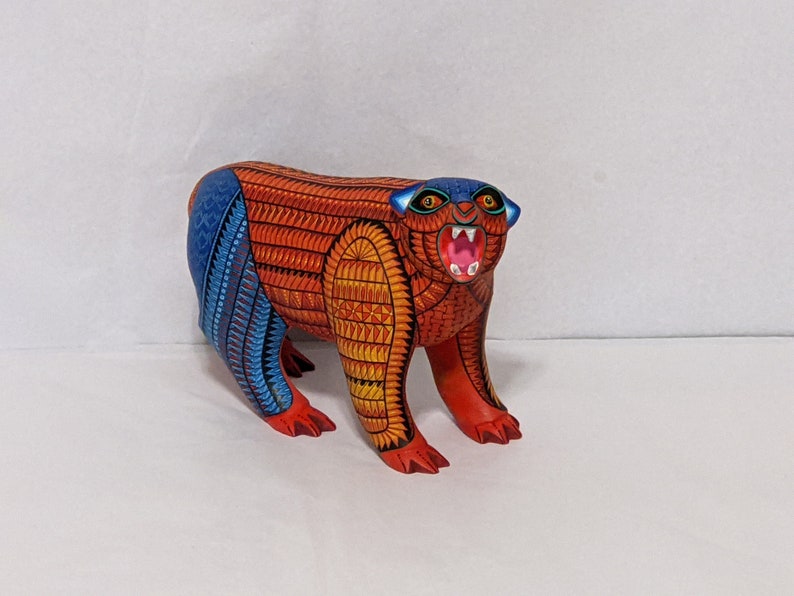 5.5 Inches in Height Original Handmade, Hand Painted Animal, Wood Carving with Irate Eyes, Copper Colored Tail, Colorful Patterned Body, Blue Colored Hind legs, Bear Alebrije, Oaxaca Art, Unique Statue from https://luv2brd.etsy.com