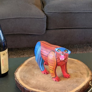 5.5 Inches in Height Original Handmade, Hand Painted Animal, Wood Carving with Irate Eyes, Copper Colored Tail, Colorful Patterned Body, Blue Colored Hind legs, Bear Alebrije, Oaxaca Art, Unique Statue from https://luv2brd.com
